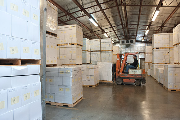A forklift maneuvers in Navarro's case-goods warehouse, insulated and air-conditioned