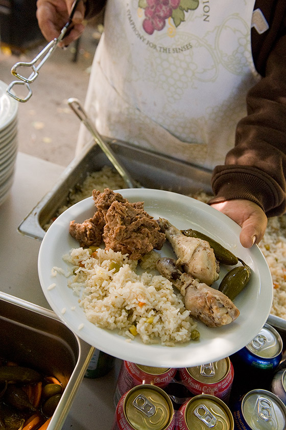 A plate of homecooked chicken, rice and peppers, served to the vineyard crew for breakfast after picking grapes at night.
