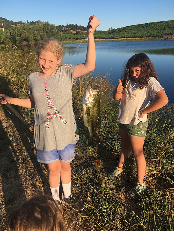 Kids holding up a caught fish