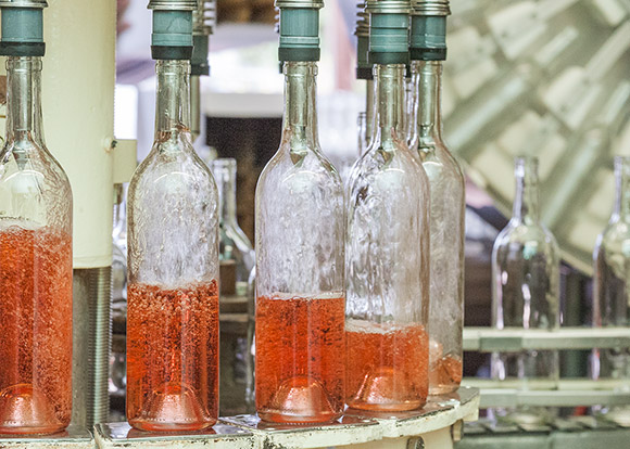 Rose wine being filled in the winery on a rotating platform.