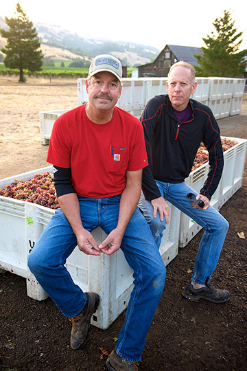 Casey Hartlip and Jim Klein, Navarro's winemaker, sitting on bins of Gewürztraminer grapes harvested from Valley Foothills Vineyard, managed by Casey.