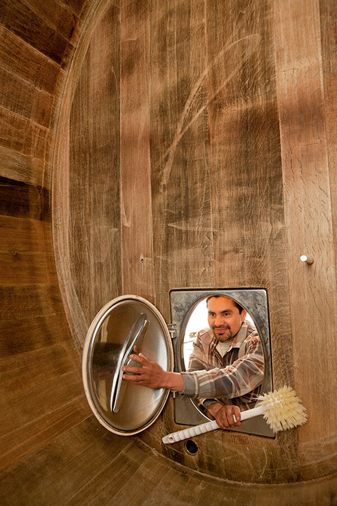 Ulises about to enter an oak oval to scrub it down on the inside.