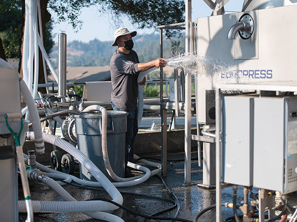 Alfredo, doing the hard work of cleaning the winery crush pad.