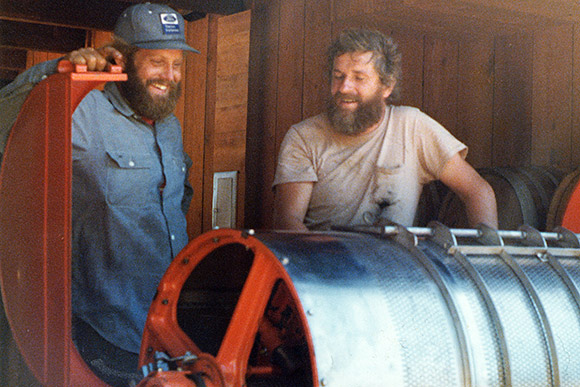 Ted showing off his new wine grape press to neighbor Mark in 1977