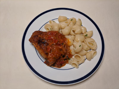 Plate of Poulet au Verjus with buttered noodles